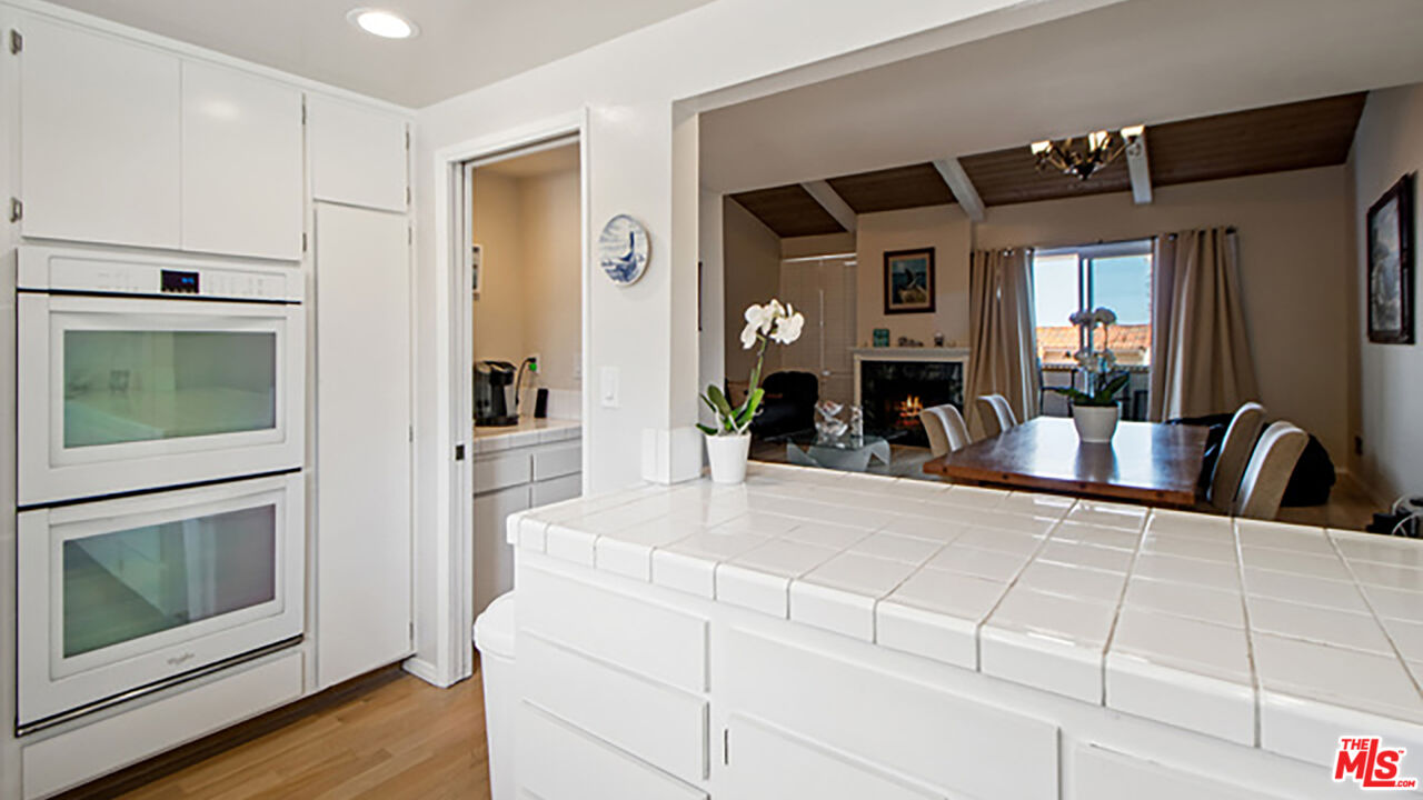 28286 Rey De Copas Lane Malibu, CA 90265 - Photo 7 of 26 a kitchen with granite countertop a stove and a microwave