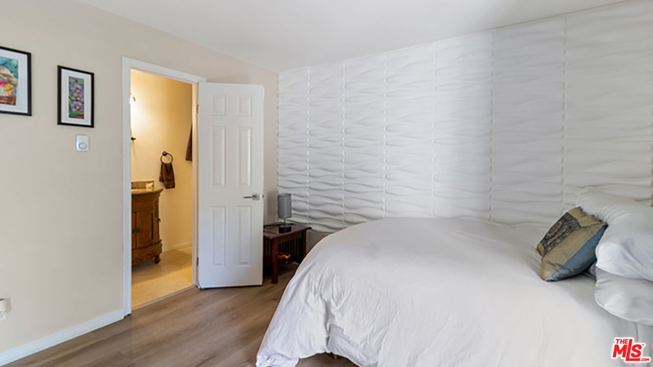 28286 Rey De Copas Lane Malibu, CA 90265 - Photo 8 of 26 a bedroom with a bed and a walk in closet