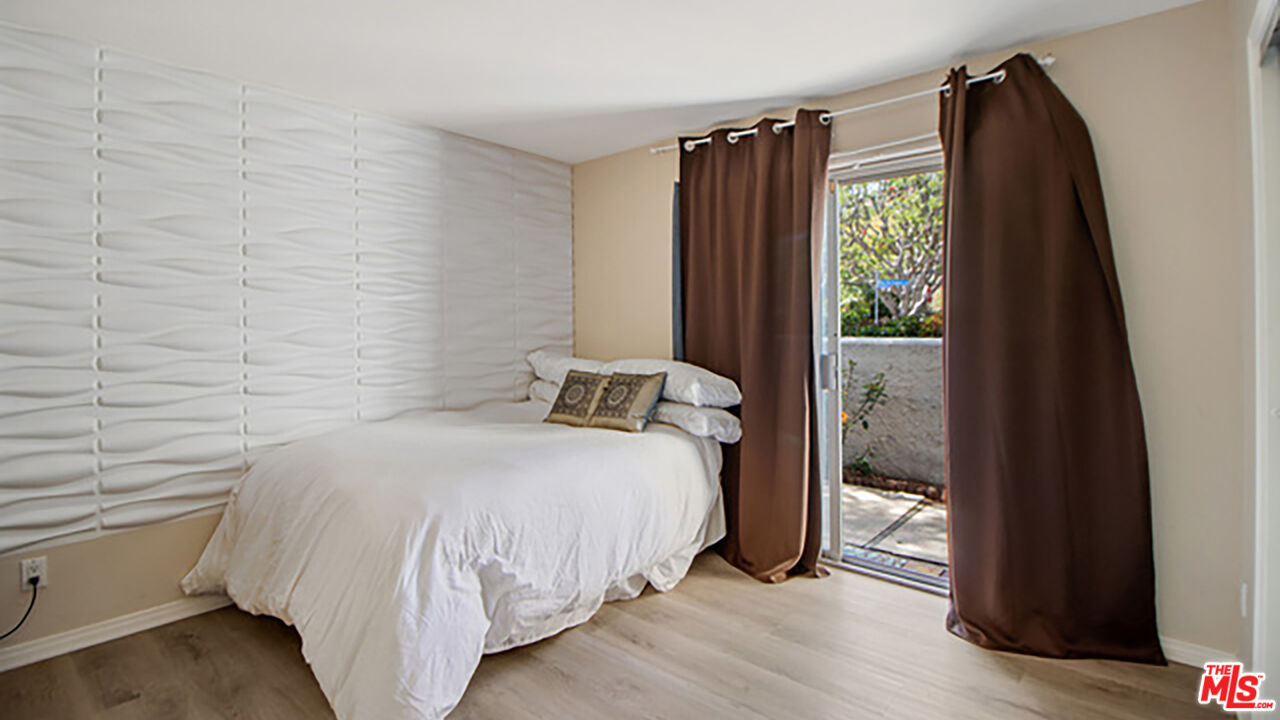 28286 Rey De Copas Lane Malibu, CA 90265 - Photo 9 of 26 a bedroom with a bed and a window