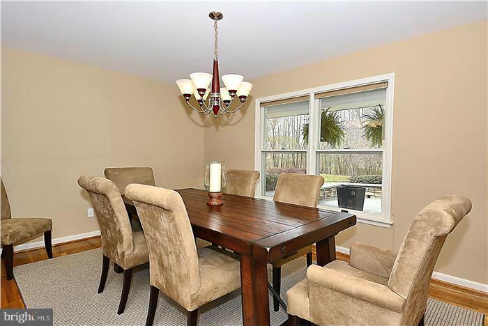 2201 Corbett Road Monkton, MD 21111 - Photo 12 of 30 a view of a dining room with furniture wooden floor and a chandelier