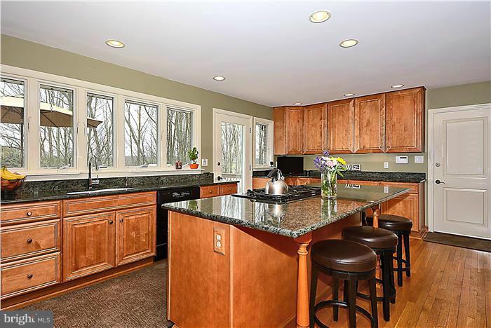 2201 Corbett Road Monkton, MD 21111 - Photo 8 of 30 a kitchen with granite countertop a stove a sink a counter space and dining table