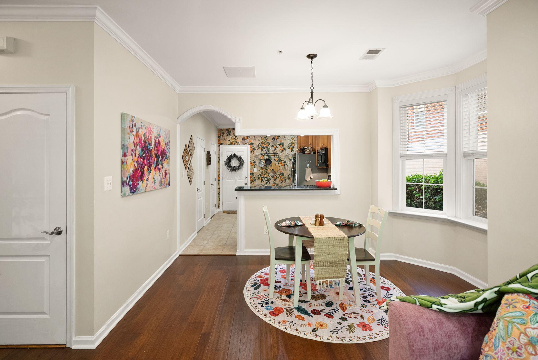 12414 A Liberty Bridge Road Fairfax, VA 22033 - Photo 7 of 38 a view of a dining room with furniture a kitchen and wooden floor