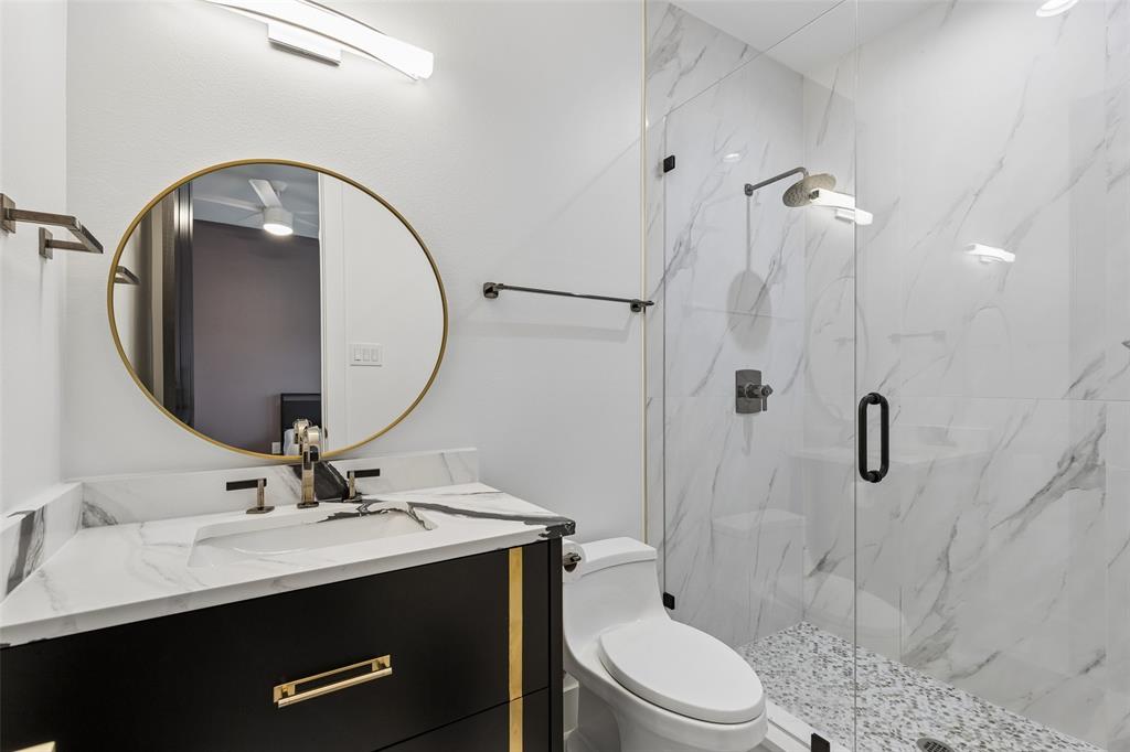 1053 Sedalia Road Van Alstyne, TX 75495 - Photo 19 of 40 a bathroom with a sink a toilet and a mirror