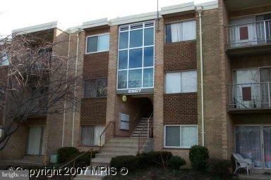 2909 Charing Cross Road, Unit 8/8 Falls Church, VA 22042 - Photo 1 of 1 a front view of a house with a garden