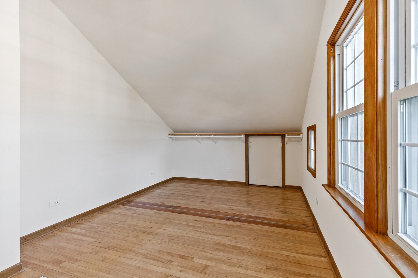 305 Olmsted Road Riverside, IL 60546 - Photo 13 of 33 a view of an empty room with wooden floor and a window