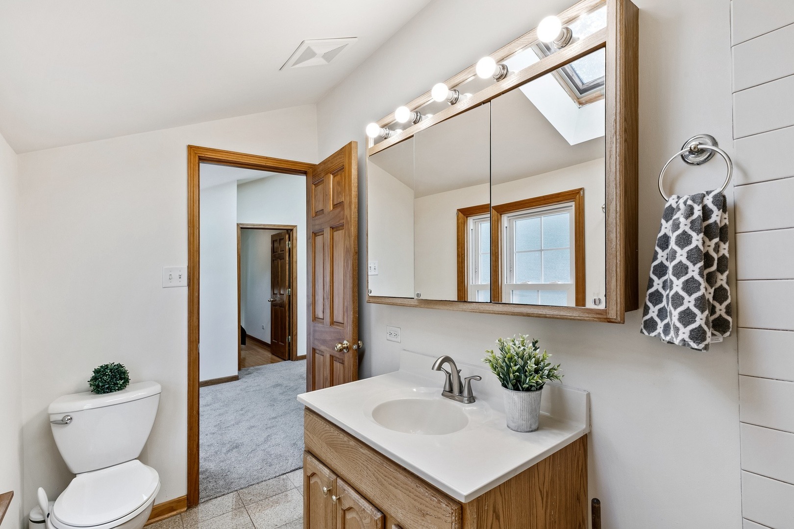 305 Olmsted Road Riverside, IL 60546 - Photo 15 of 33 a bathroom with a sink vanity mirror and toilet