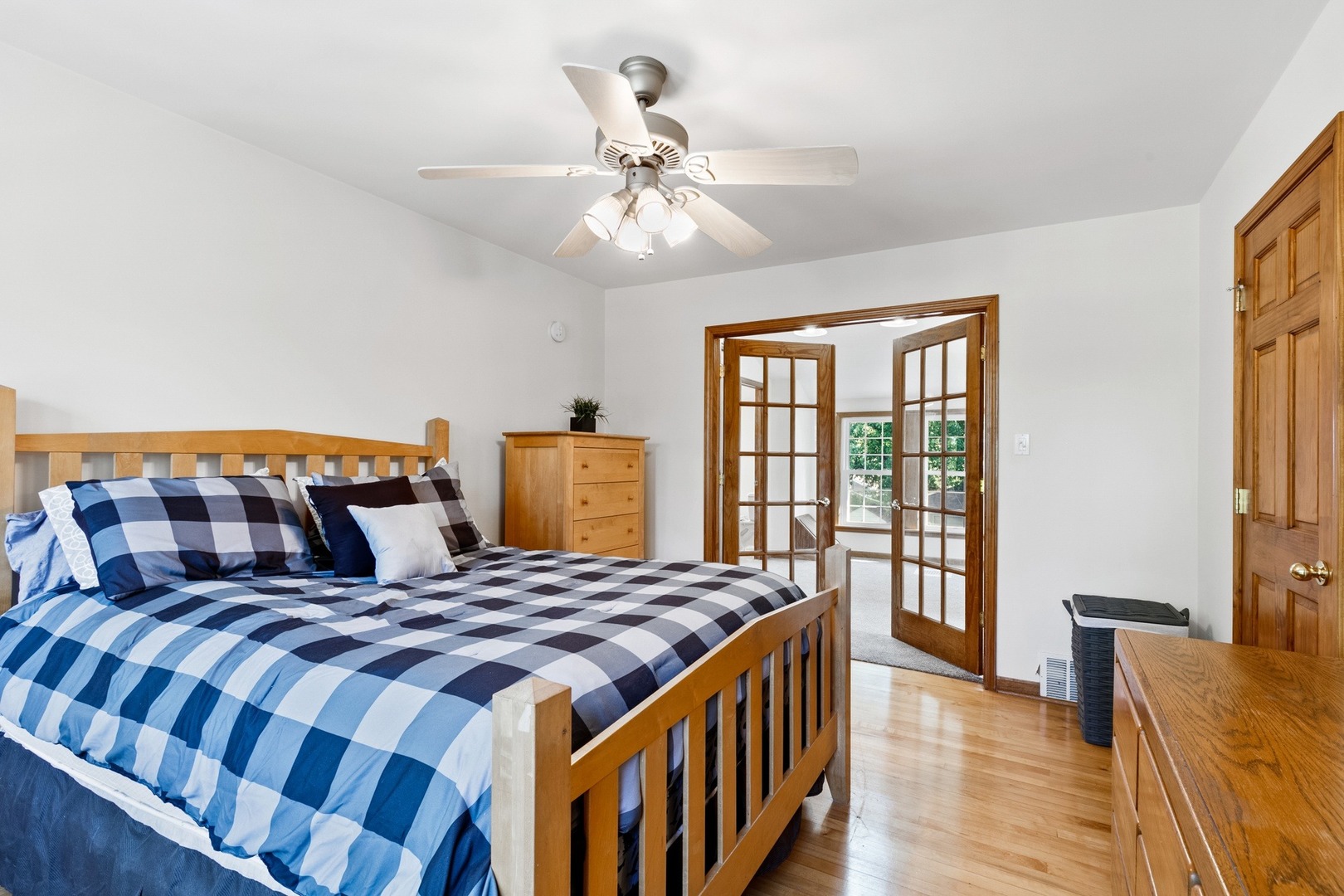 305 Olmsted Road Riverside, IL 60546 - Photo 18 of 33 a bedroom with a large bed and a chandelier