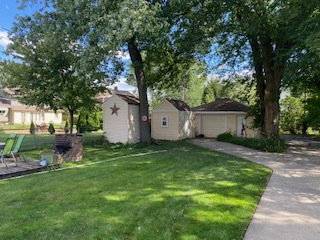 305 Olmsted Road Riverside, IL 60546 - Photo 24 of 33 a view of a backyard with table and chairs and a large tree
