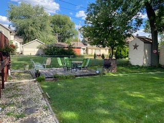 305 Olmsted Road Riverside, IL 60546 - Photo 25 of 33 a view of a house with backyard sitting area and garden