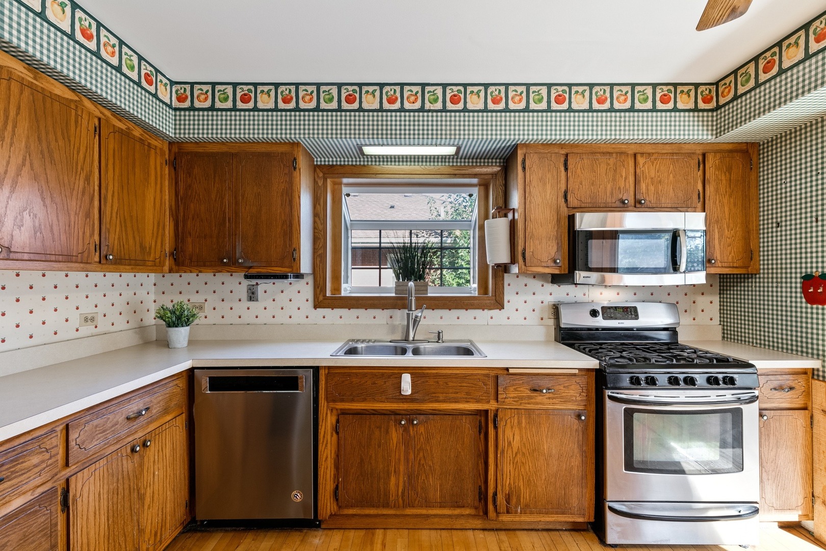 305 Olmsted Road Riverside, IL 60546 - Photo 9 of 33 a kitchen with stainless steel appliances a sink stove and cabinets