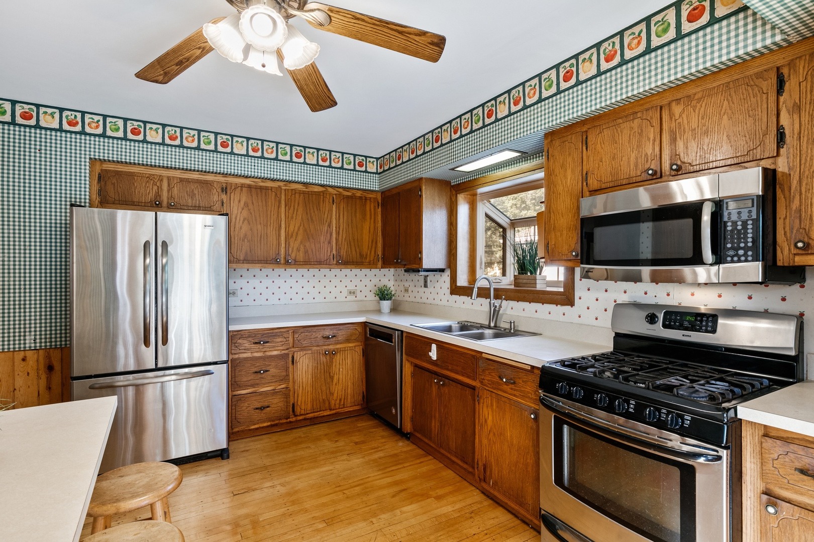 305 Olmsted Road Riverside, IL 60546 - Photo 10 of 33 a kitchen with stainless steel appliances a stove a sink and a microwave