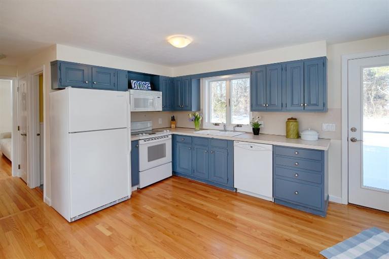 47 Sandy Neck Road East Sandwich, MA 02537 - Photo 7 of 35 a kitchen with a refrigerator a stove a sink cabinets and a window