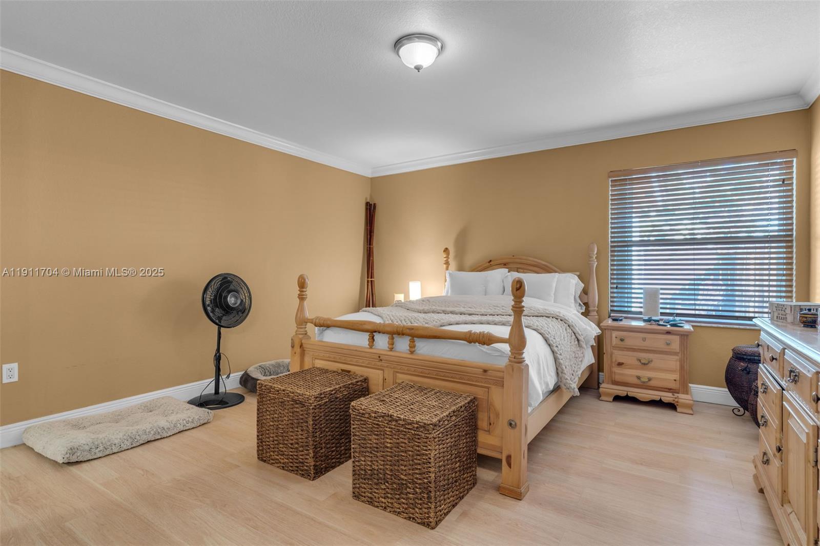 10523 Southwest 161st Place Miami, FL 33196 - Photo 12 of 26 a bedroom with a bed and a chandelier