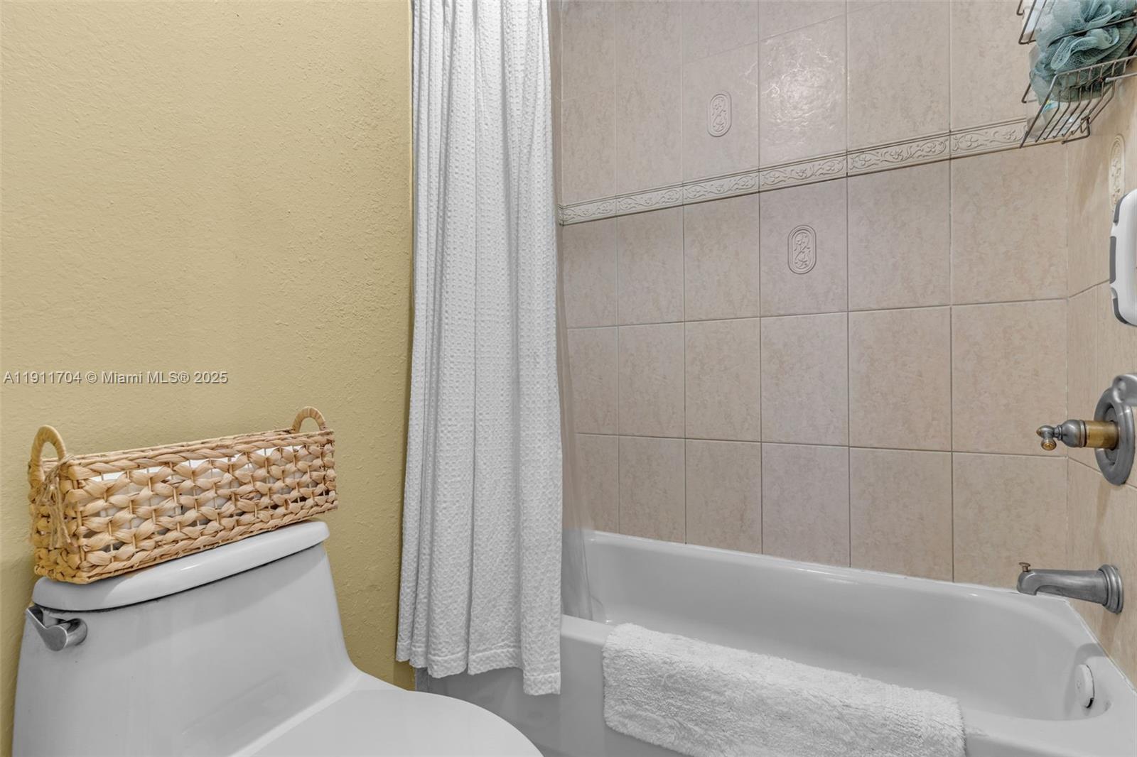 10523 Southwest 161st Place Miami, FL 33196 - Photo 15 of 26 a bathroom with a toilet and a bathtub