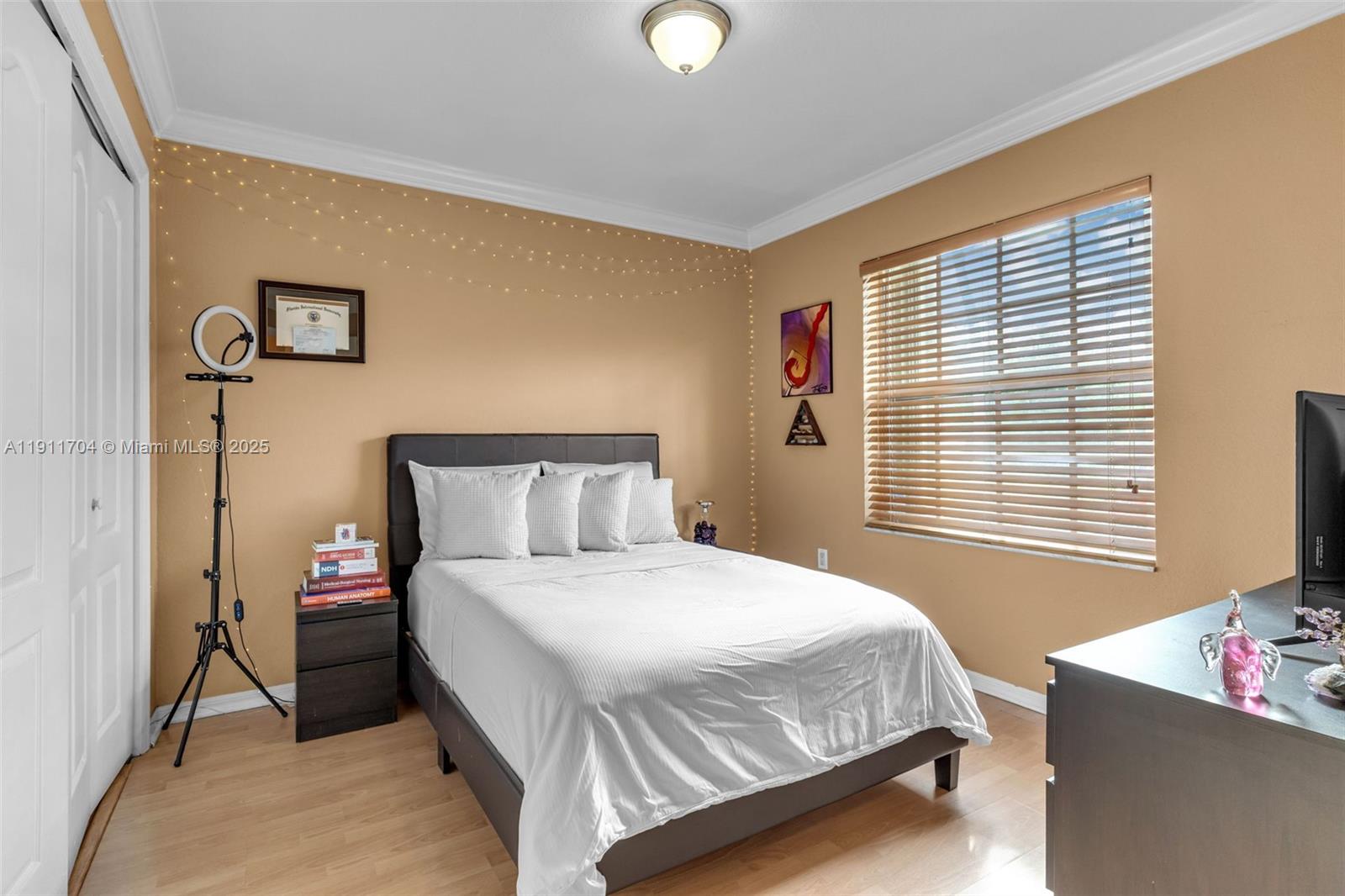 10523 Southwest 161st Place Miami, FL 33196 - Photo 16 of 26 a bedroom with a bed and a window