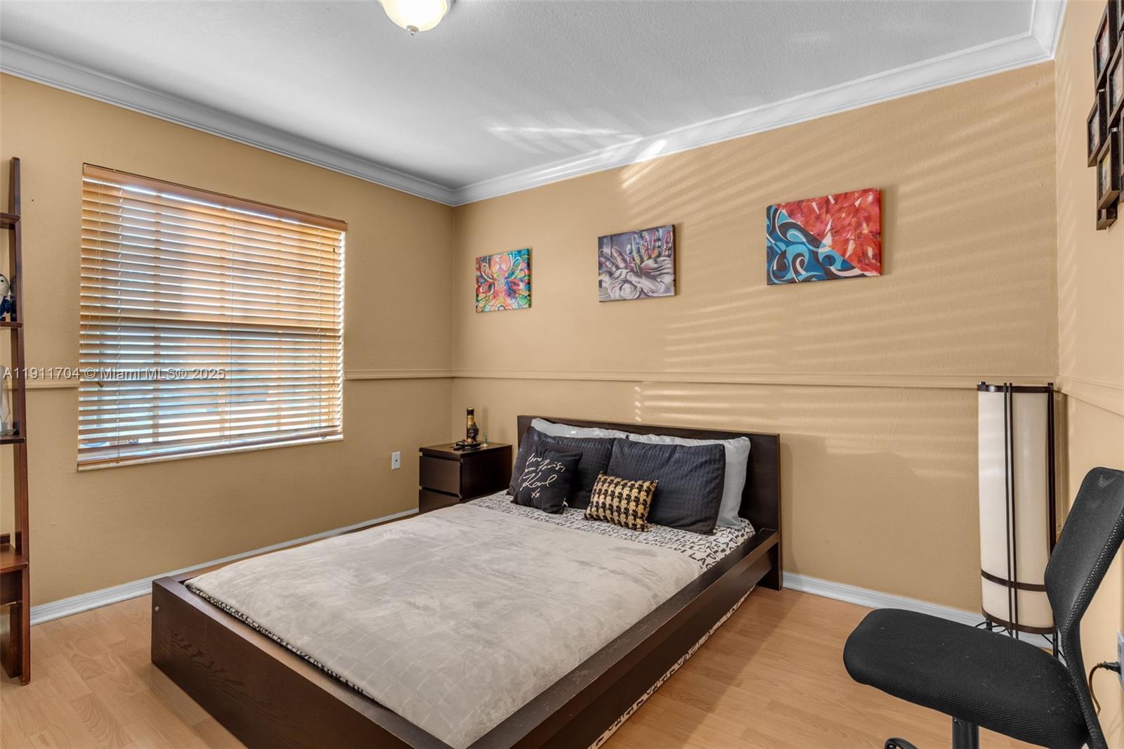 10523 Southwest 161st Place Miami, FL 33196 - Photo 17 of 26 a bedroom with bed and wooden floor