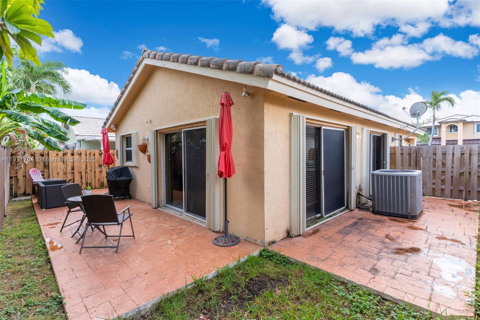 10523 Southwest 161st Place Miami, FL 33196 - Photo 20 of 26 a view of a house with backyard porch and sitting area