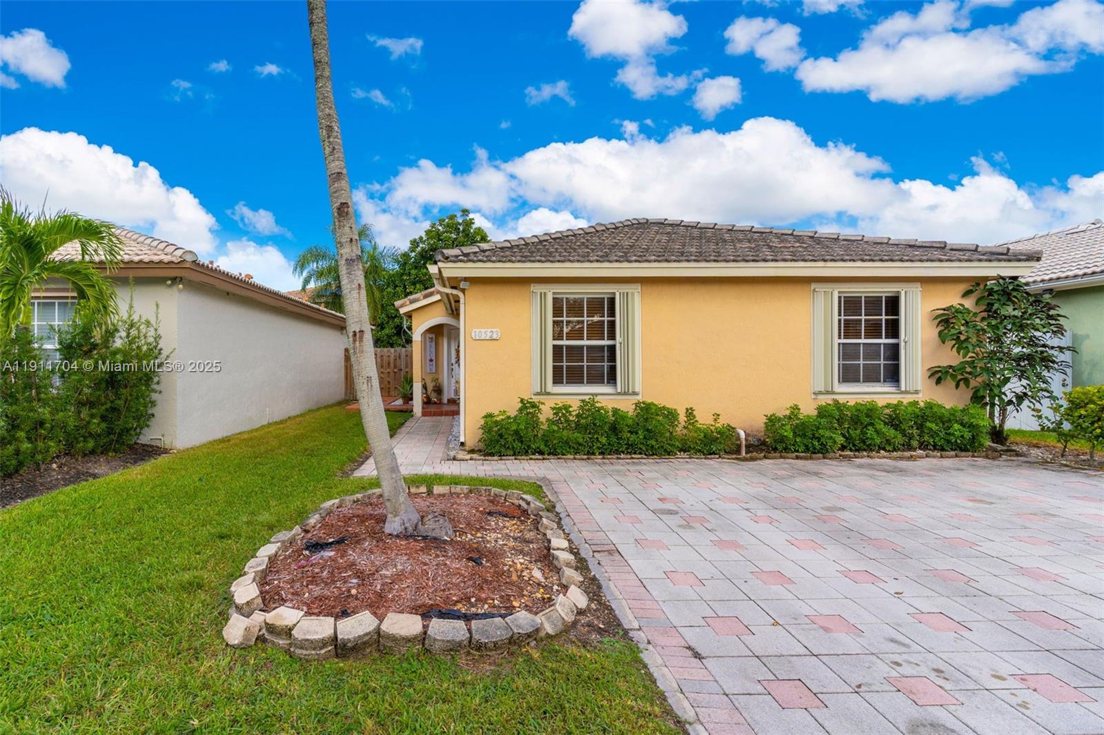10523 Southwest 161st Place Miami, FL 33196 - Photo 2 of 26 a front view of a house with garden