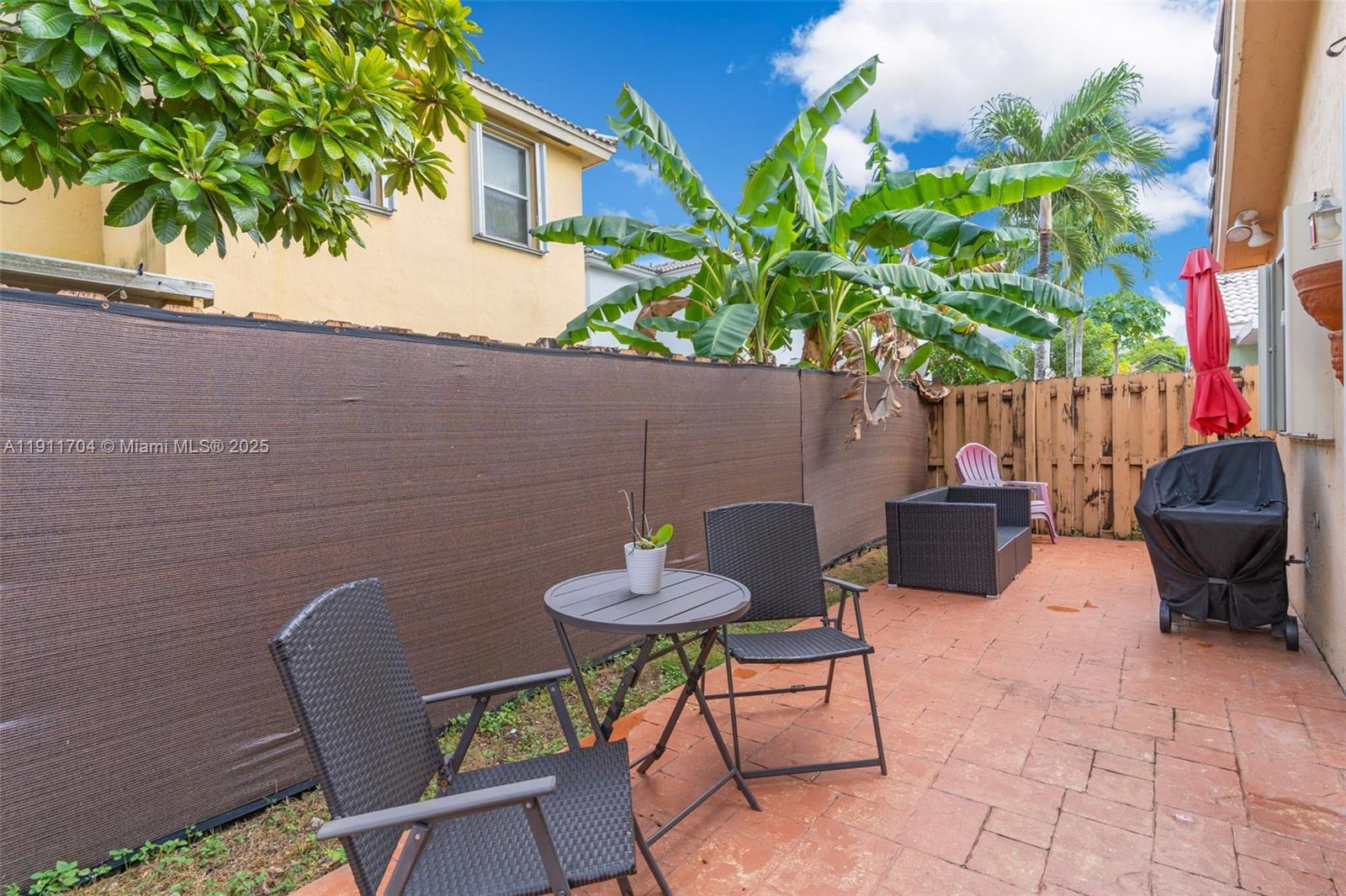 10523 Southwest 161st Place Miami, FL 33196 - Photo 21 of 26 a backyard of a house with table and chairs