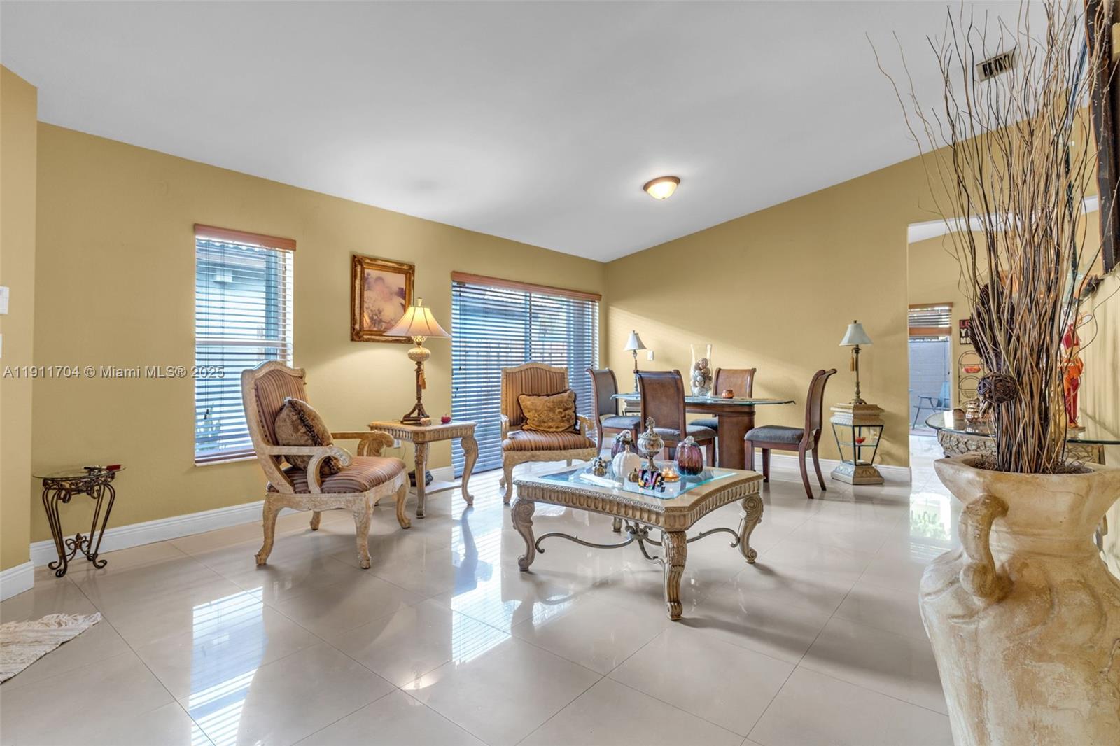 10523 Southwest 161st Place Miami, FL 33196 - Photo 4 of 26 a living room with furniture and a painting on the wall