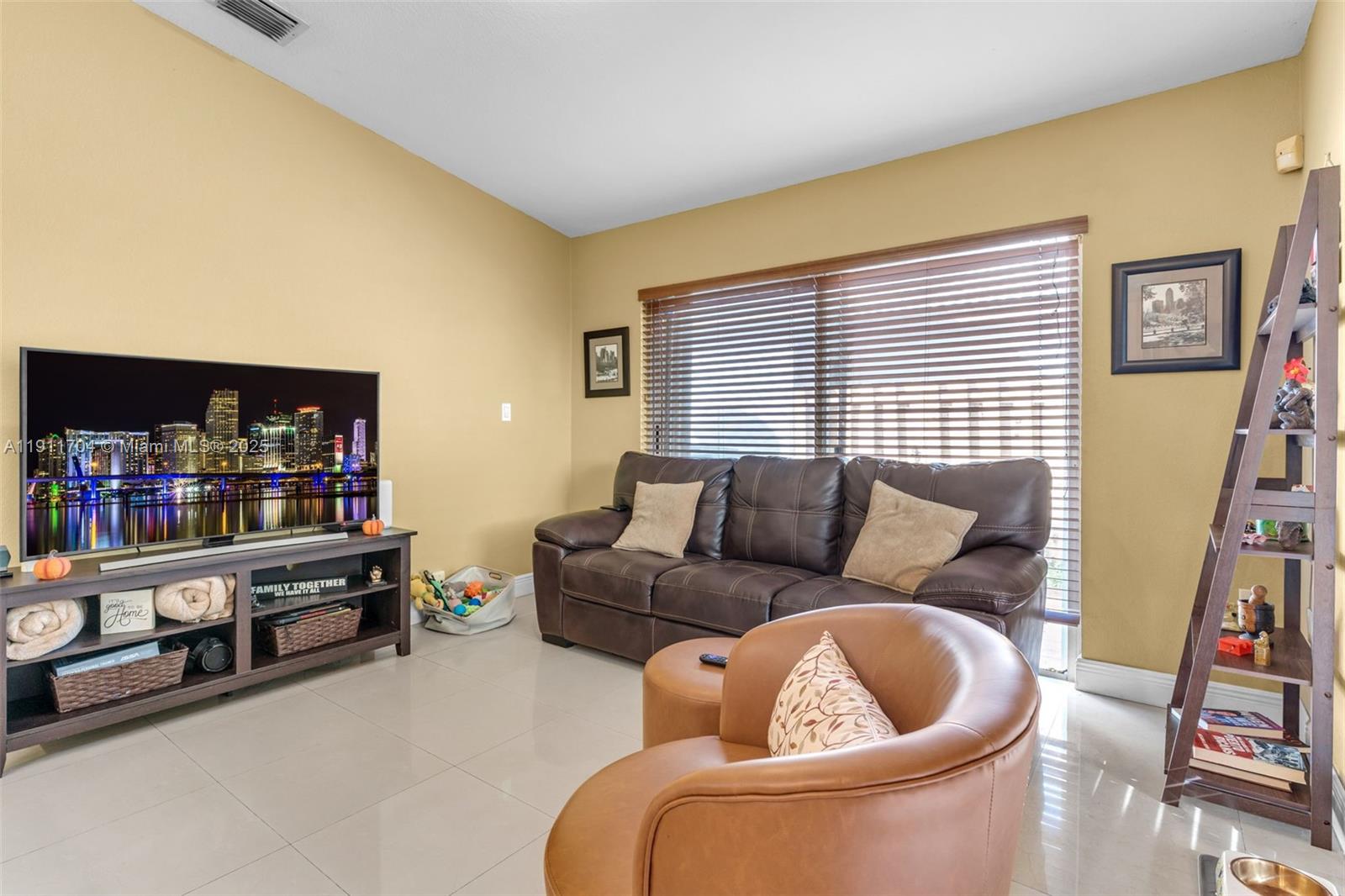 10523 Southwest 161st Place Miami, FL 33196 - Photo 6 of 26 a living room with furniture and a book shelf