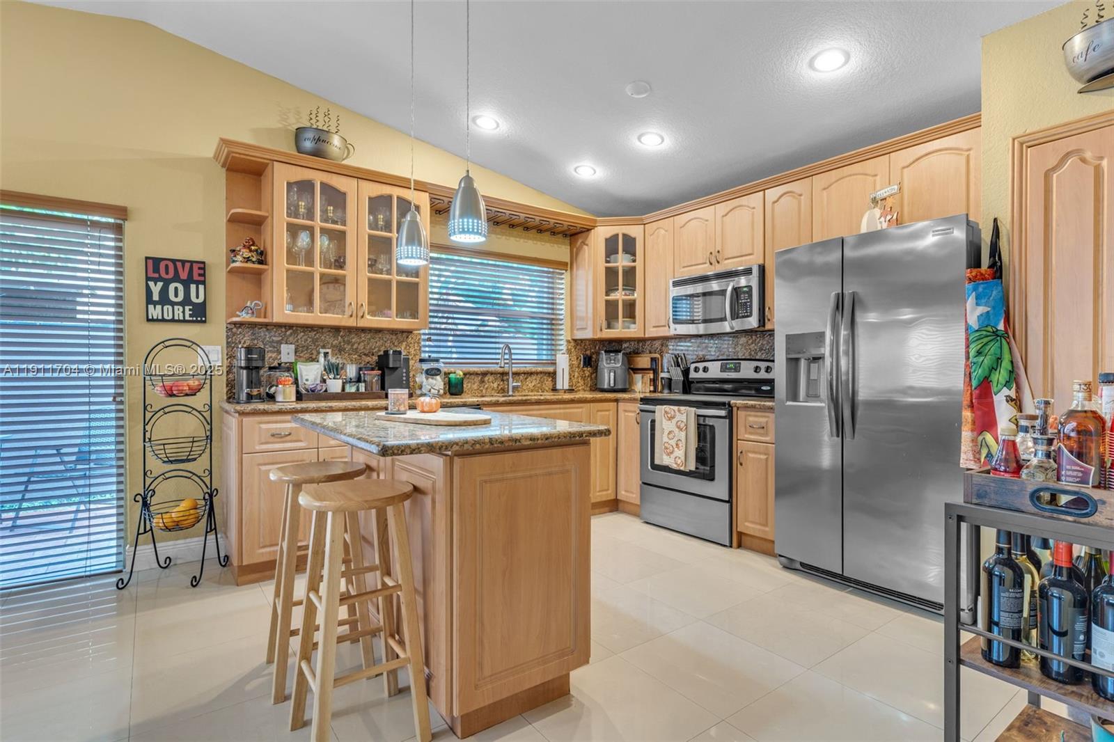 10523 Southwest 161st Place Miami, FL 33196 - Photo 8 of 26 a kitchen with stainless steel appliances granite countertop a refrigerator and a stove
