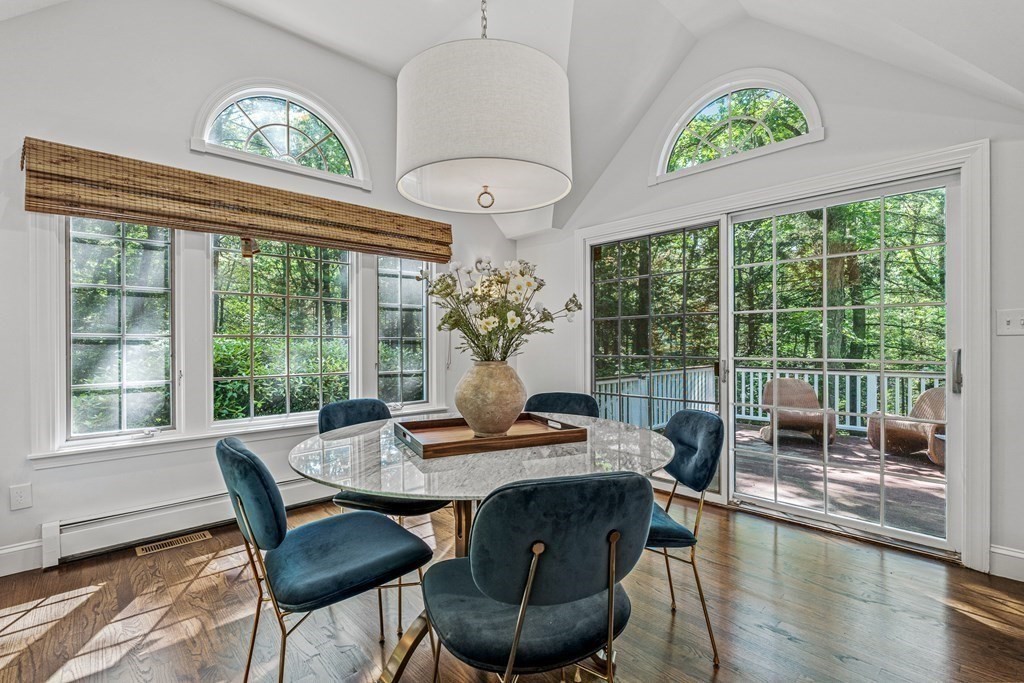 255 Westerly Road Weston, MA 02493 - Photo 13 of 35 a view of a dining room with furniture a chandelier and wooden floor