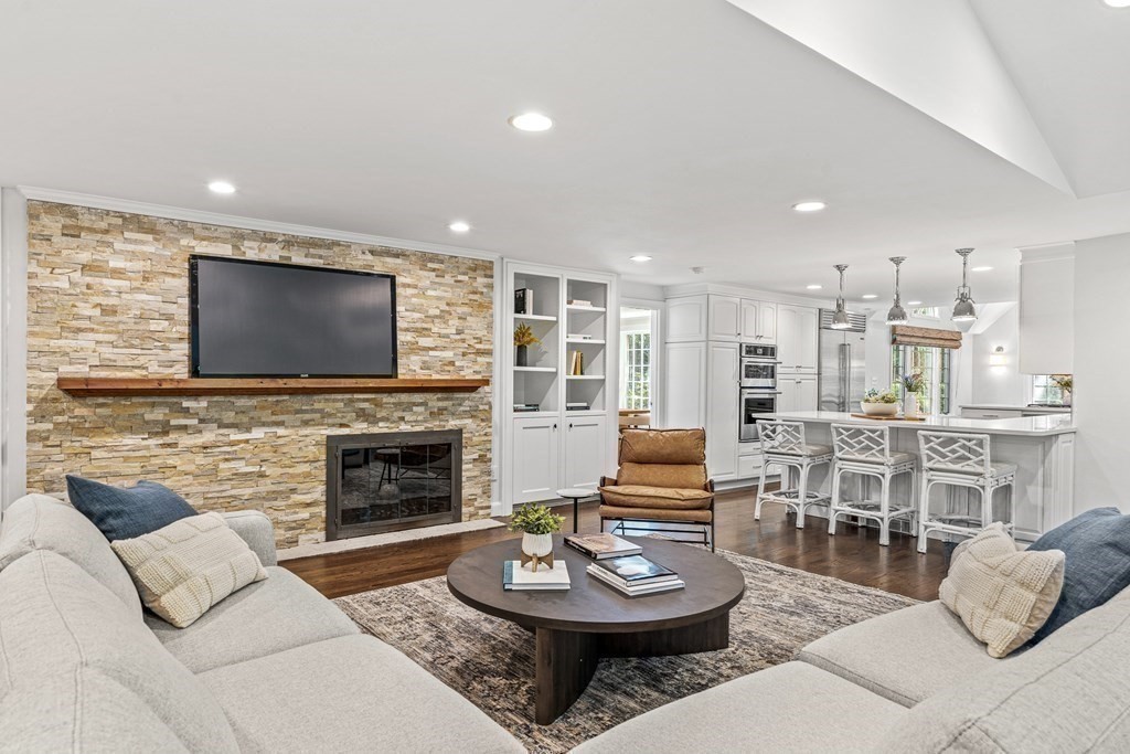 255 Westerly Road Weston, MA 02493 - Photo 15 of 35 a living room with furniture a fireplace and a flat screen tv