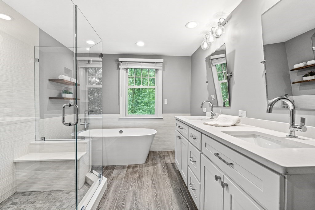 255 Westerly Road Weston, MA 02493 - Photo 23 of 35 a spacious bathroom with a double vanity sink a mirror and a bathtub