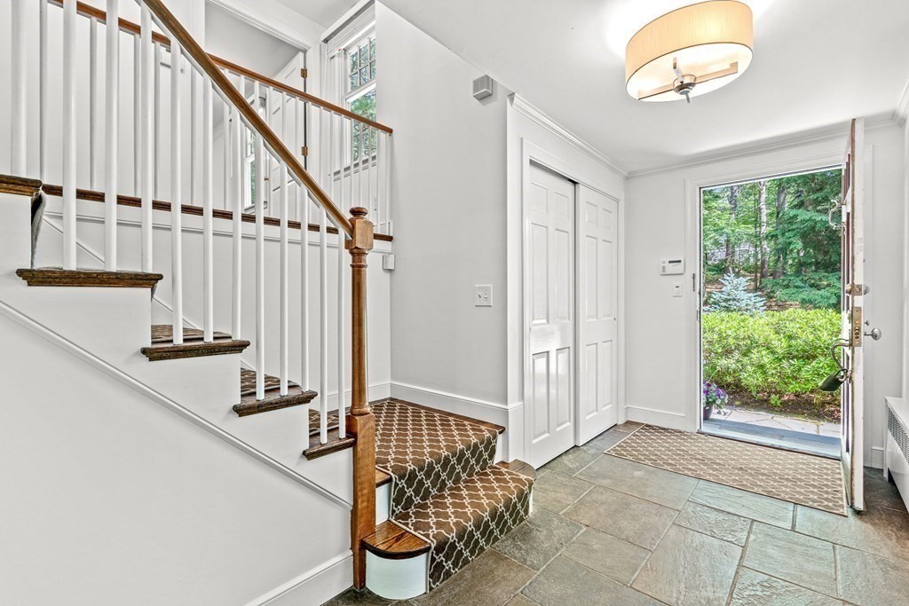255 Westerly Road Weston, MA 02493 - Photo 3 of 35 a view of staircase with lots of frames on wall and a window