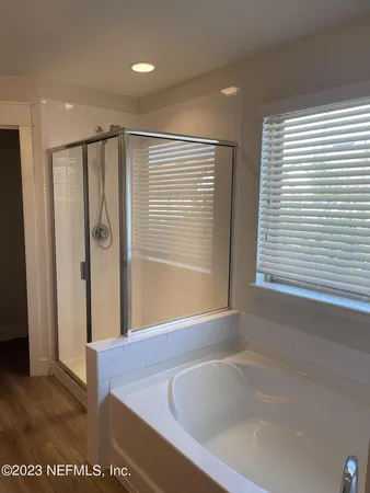 a bathroom with a bathtub and a shower