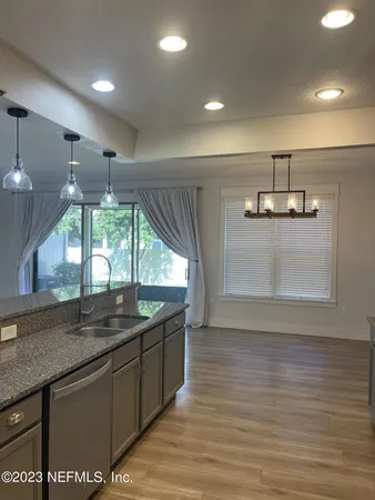 a view of a kitchen with a sink and window