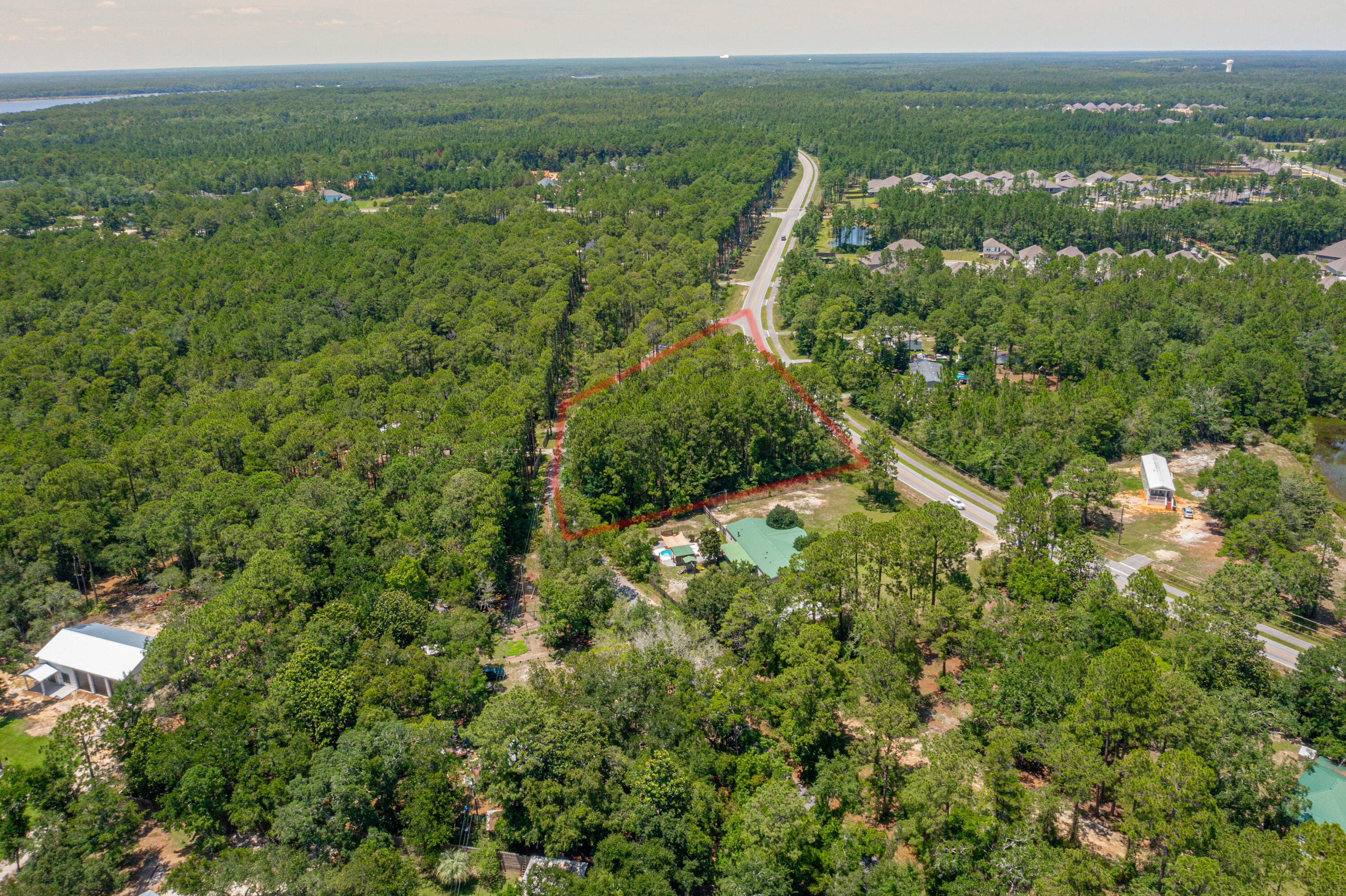83a Freeport Freeport, FL 32439 - Photo 4 of 16 an aerial view of a houses with a lush green hillside