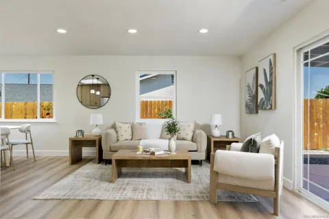 a living room with furniture and a wooden floor