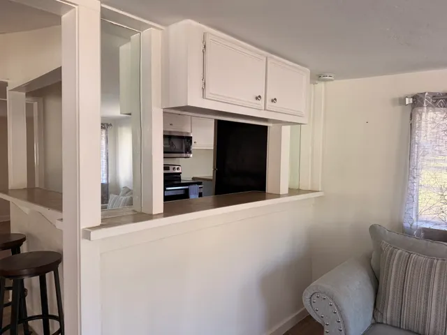 a view of kitchen with furniture and window