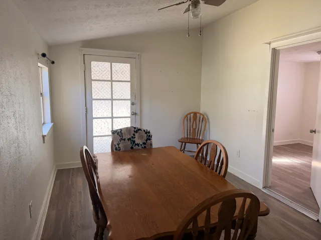 a view of a dining room with furniture and window
