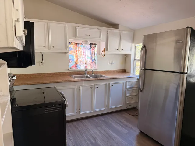 a kitchen with a refrigerator and a sink