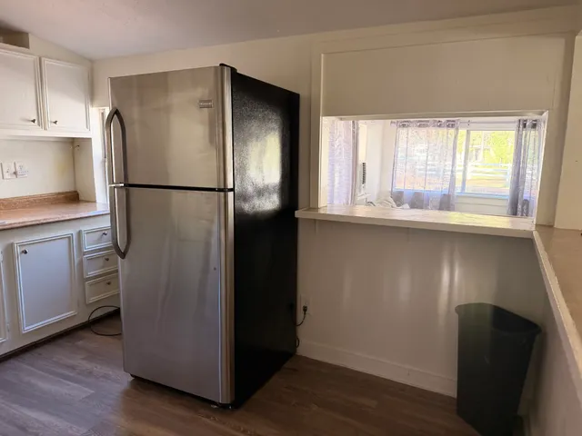 a kitchen with stainless steel appliances a refrigerator and a sink