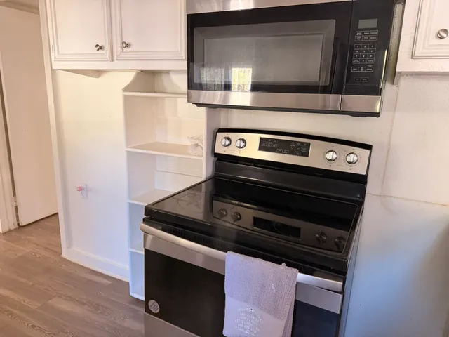 a stove top oven sitting inside of a kitchen