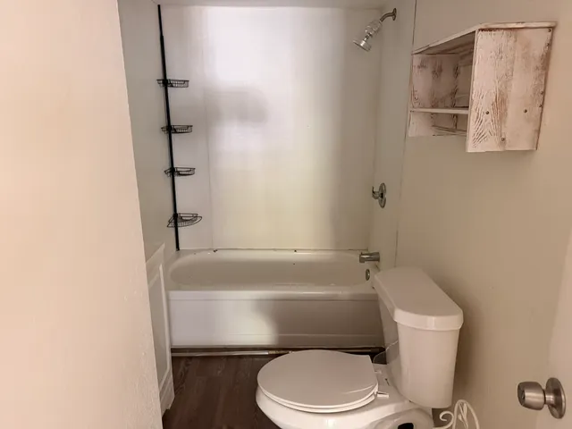 a bathroom with a toilet and a shower