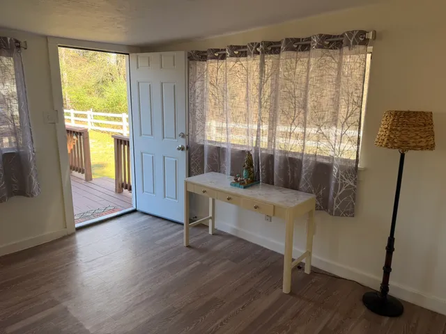a room with wooden floor and furniture