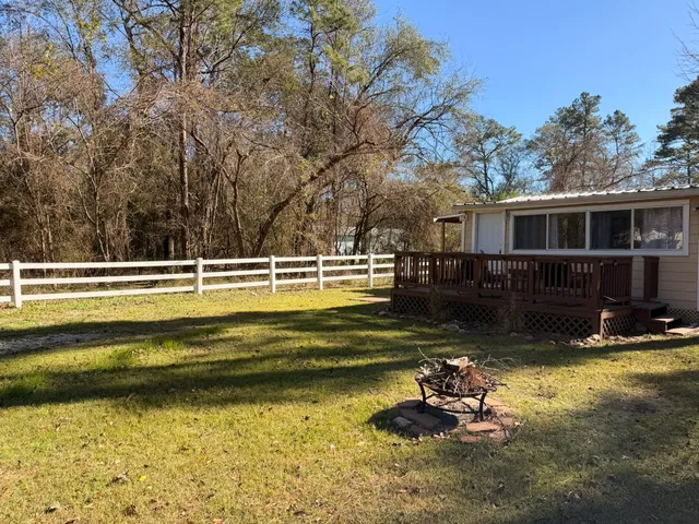 a front view of a house with swimming pool and sitting area