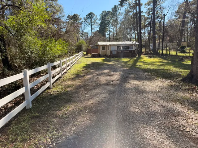 a view of a house with swimming pool and a yard