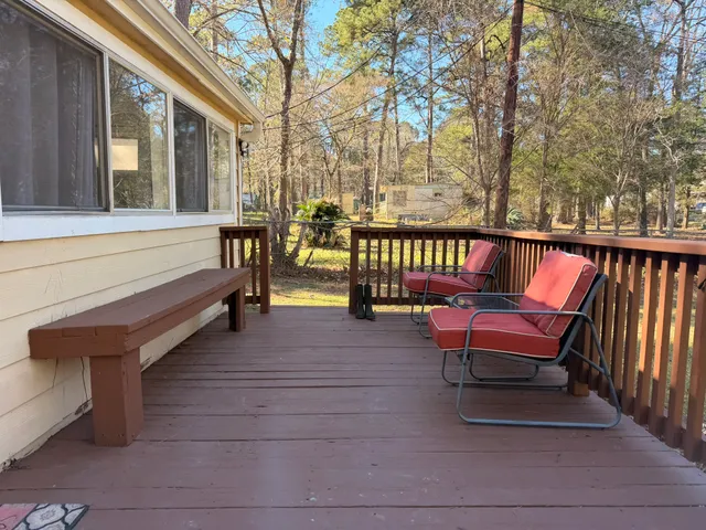 a balcony with wooden benches and a couch