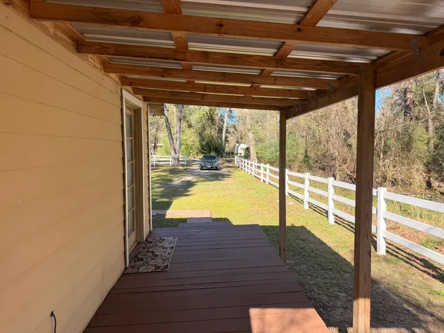 a view of swimming pool with a table and chairs in floor