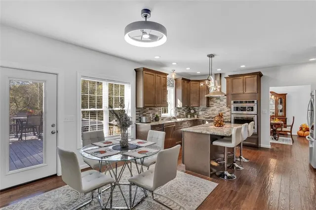 a view of a dining room with furniture window and wooden floor