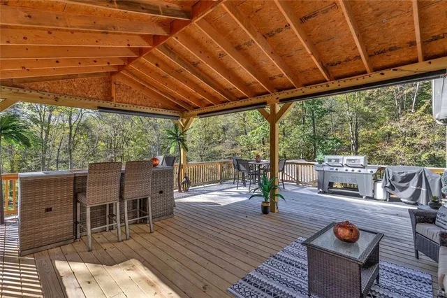 a deck view with a table and chairs under an umbrella