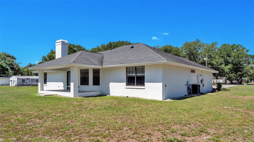 8525 North Campbell Road Lakeland, FL 33810 - Photo 10 of 45 a front view of a house with a yard