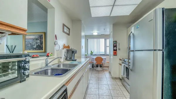 a kitchen that has a refrigerator and a sink