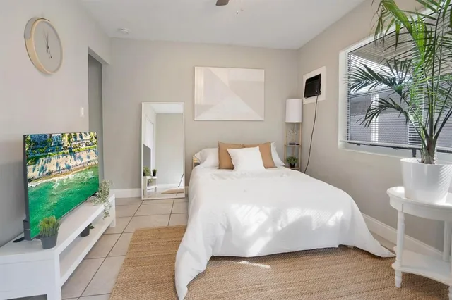 a large white bed in a white room